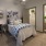 a bedroom with a bed and a chair
