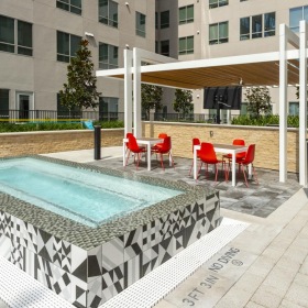 Hot tub for social gatherings or some relax time a pool with chairs around it