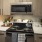 a kitchen with a stove and microwave