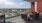 a patio with chairs and tables and a view of a city